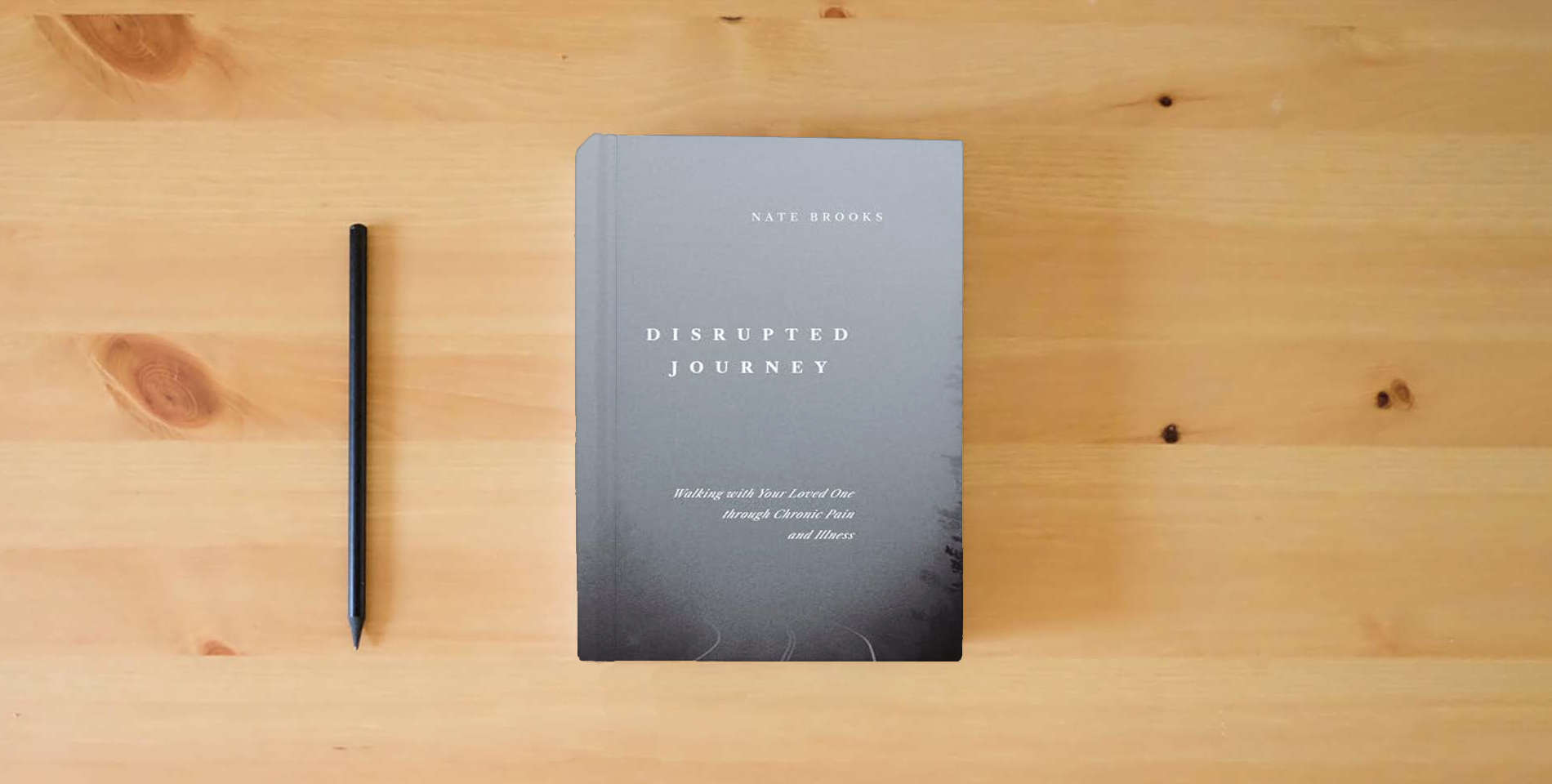 The book Disrupted Journey: Walking with Your Loved One Through Chronic Pain and Illness is on the table