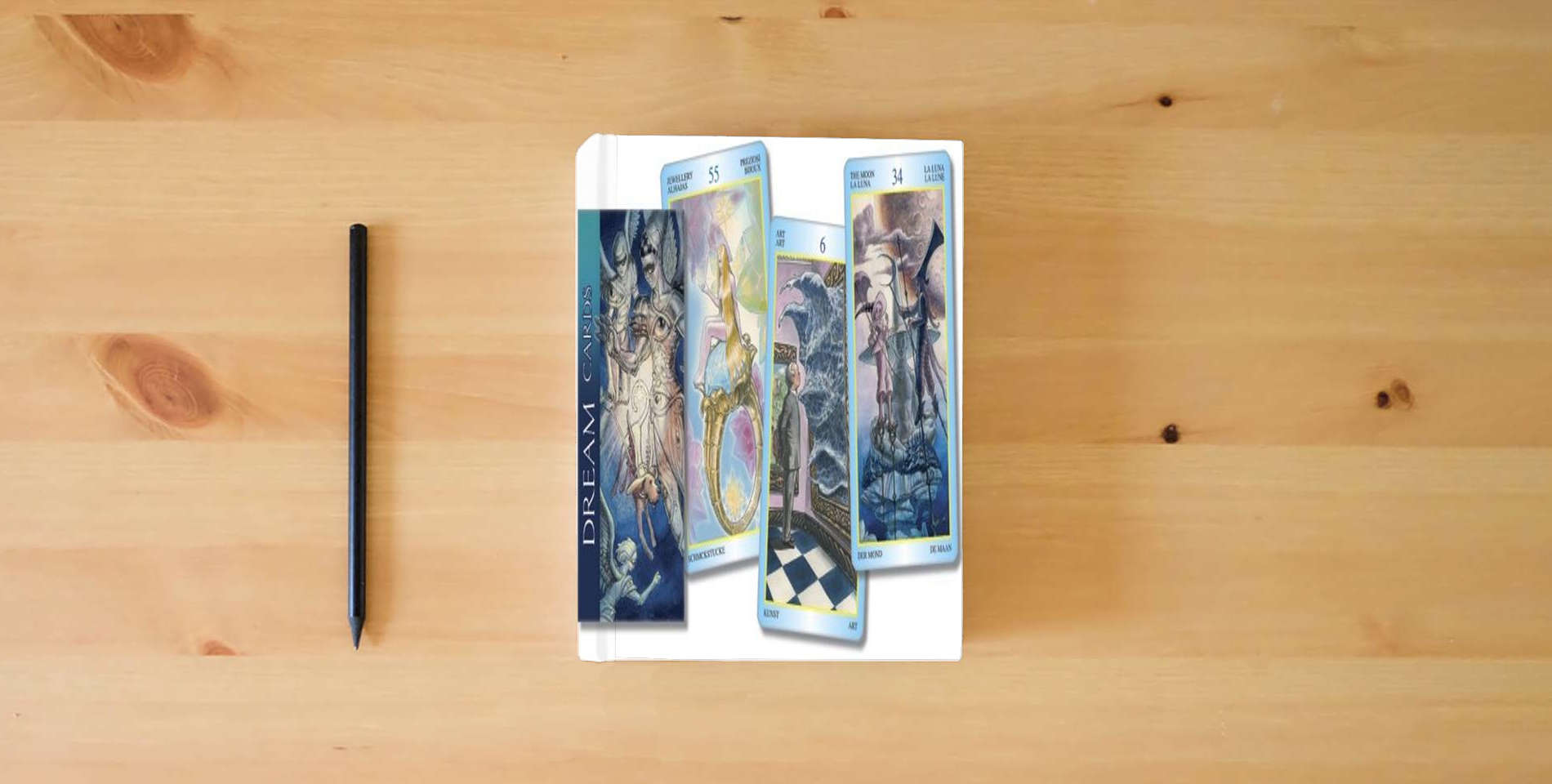 The book Dream Inspirational Cards (Lo Scarabeo Decks) (English and Spanish Edition) is on the table