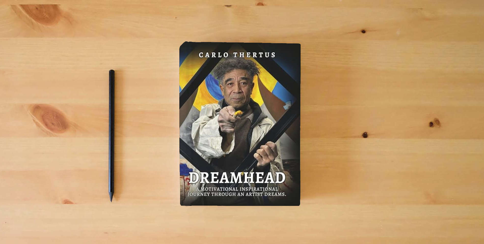 The book Dreamhead: A Motivational Inspirational Journey Through an Artist’s Dreams is on the table