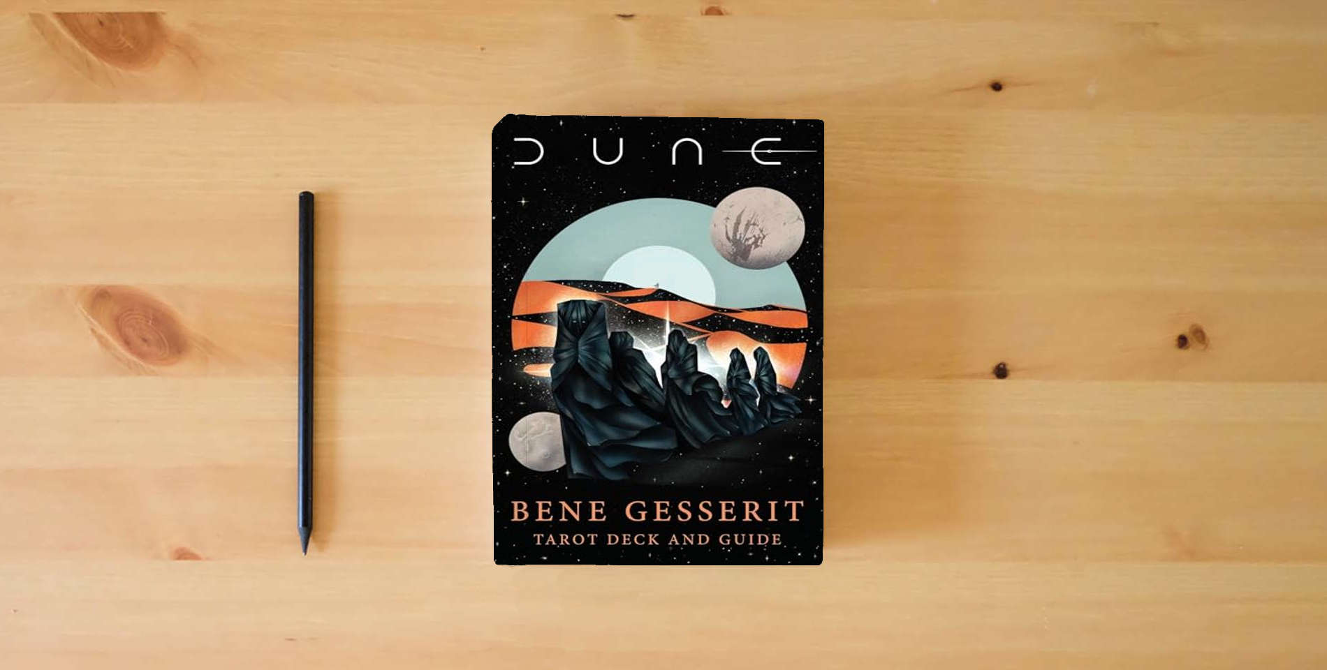 The book Dune: Bene Gesserit Tarot Deck and Guide is on the table