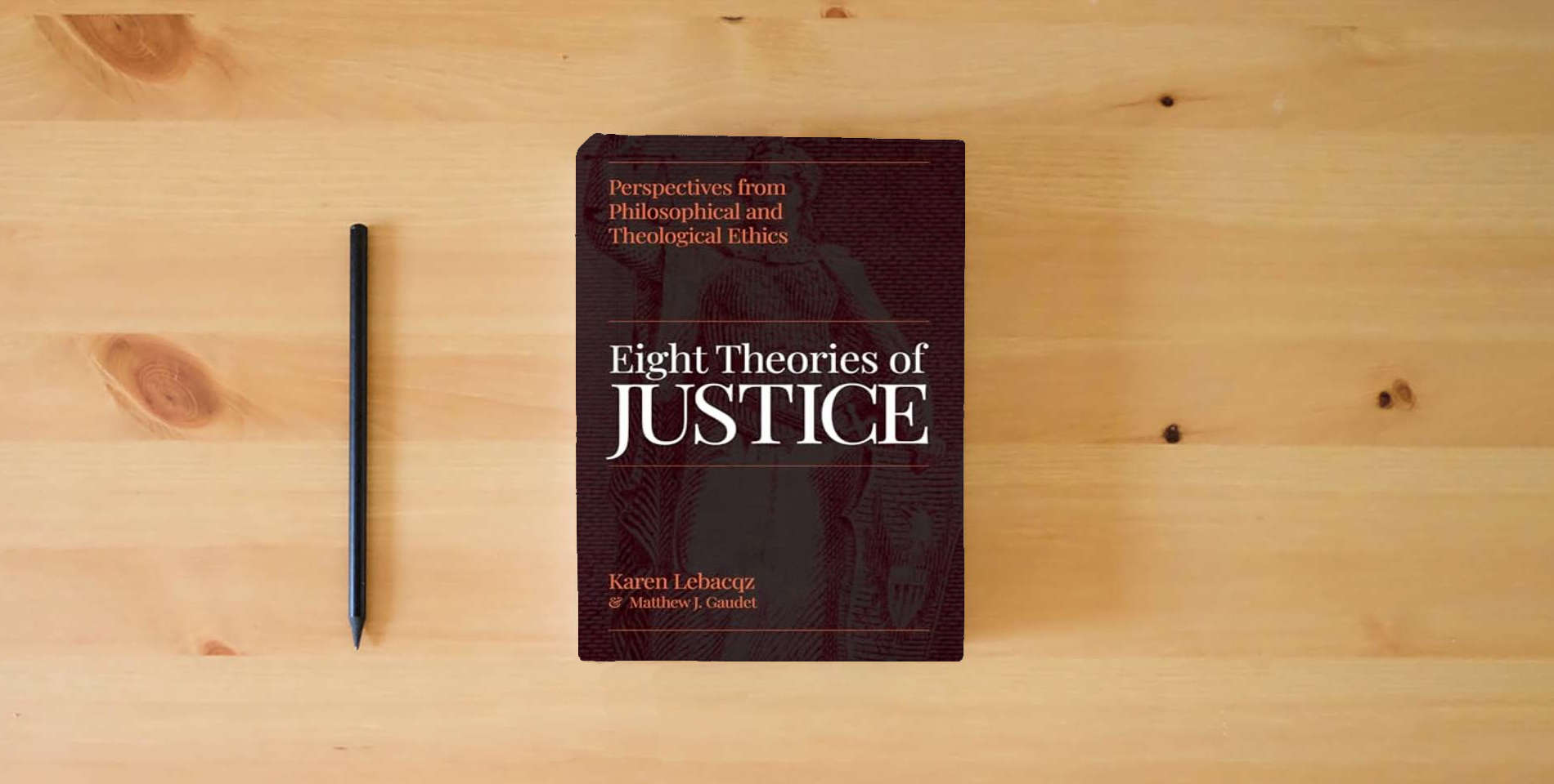 The book Eight Theories of Justice: Perspectives from Philosophical and Theological Ethics is on the table