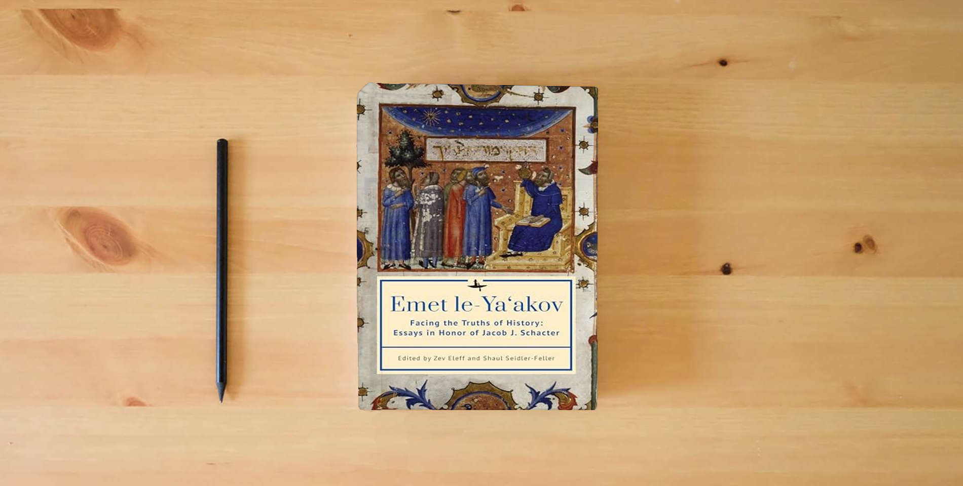 The book Emet Le-Ya'akov: Facing the Truths of History: Essays in Honor of Jacob J. Schacter is on the table