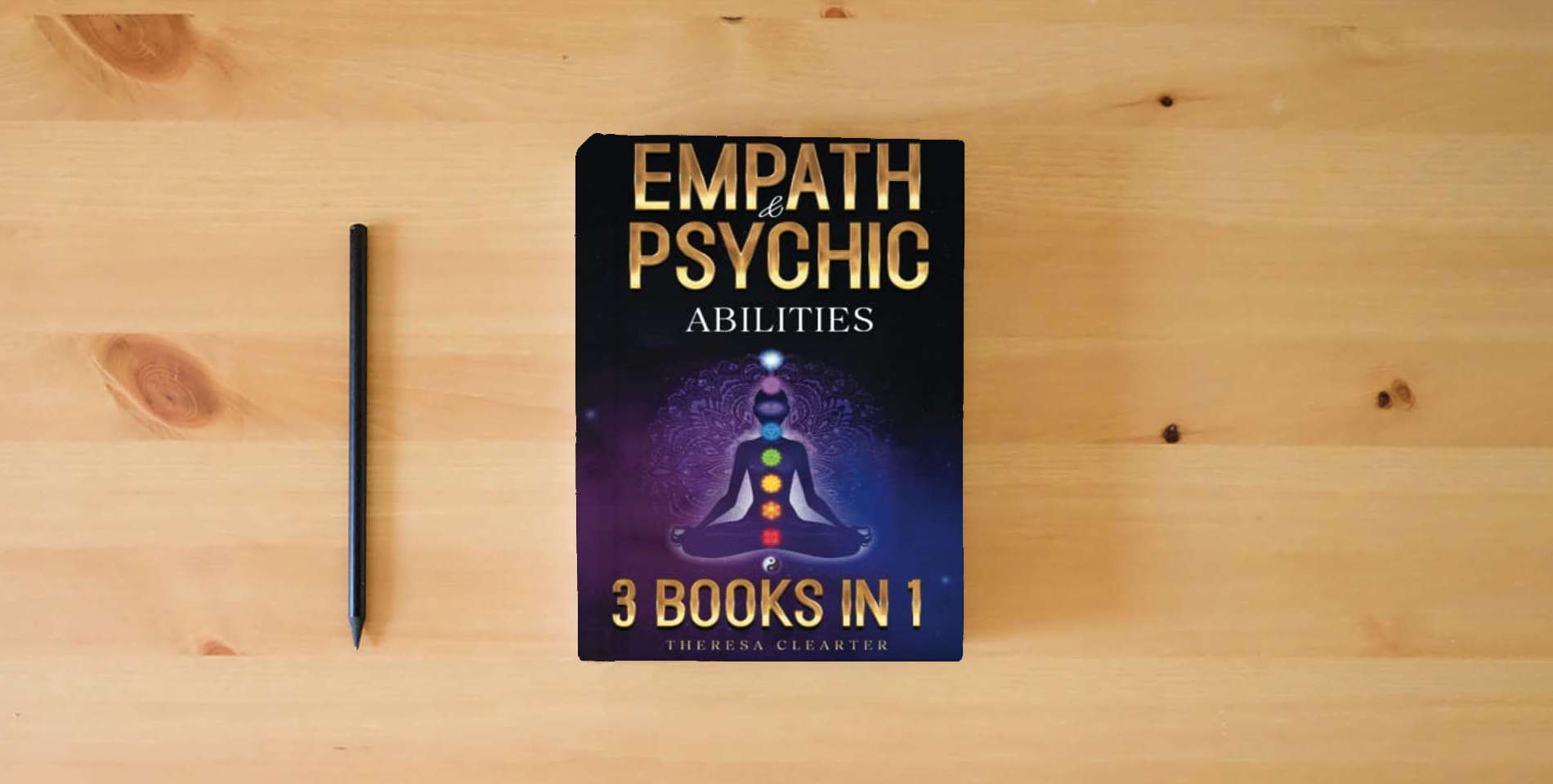 The book Empath and Psychic Abilities Bible | 3 BOOKS IN 1: Unlocking Your Inner Potential & Managing Your Psychic Gifts Through Intuition, Clairvoyance and Meditation [II EDITION] is on the table