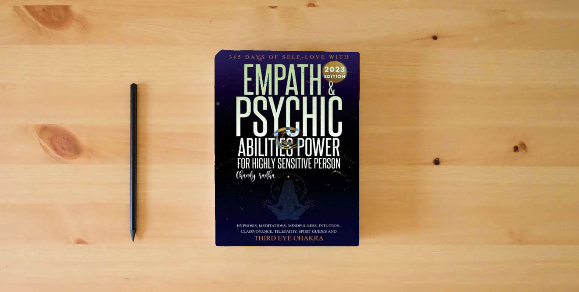 The book Empath & Psychic Abilities Power For Highly Sensitive Person: 365-Days of Self Love With : Intuition, Mindfulness, Clairvoyance, Telepathy, Spirit Guide and Third Eye Chakra is on the table