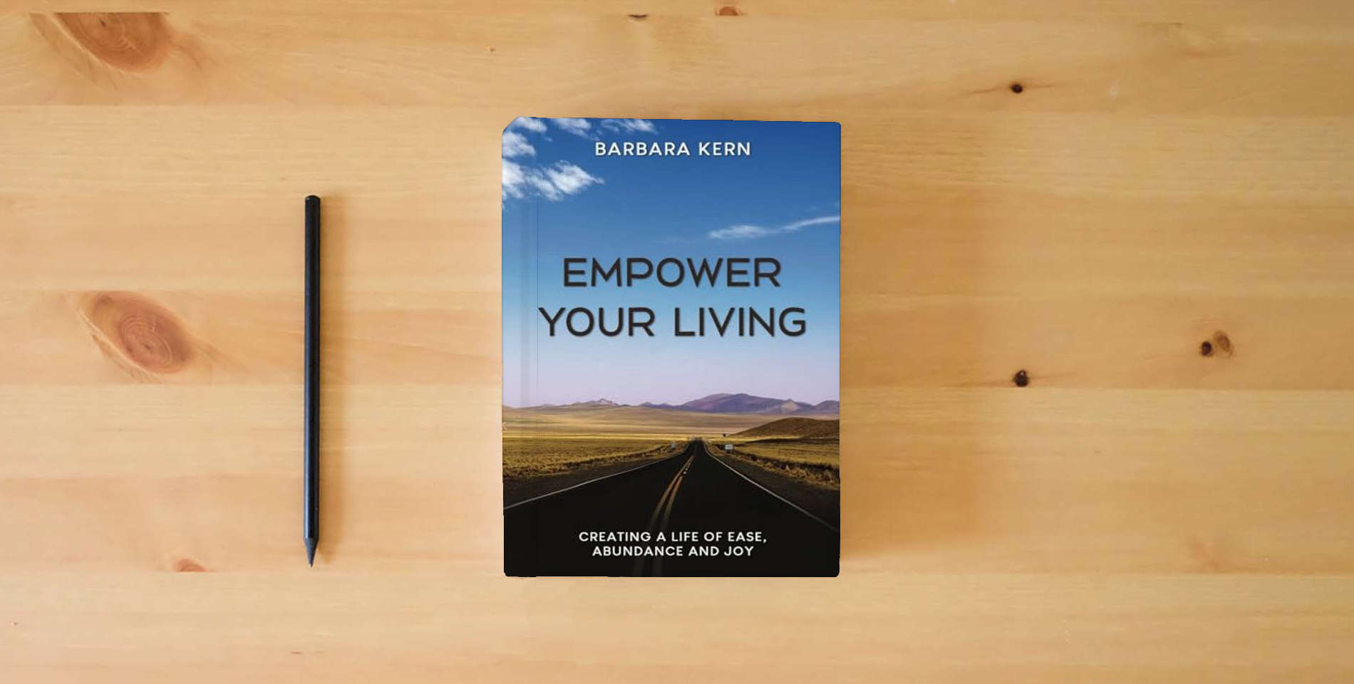 The book EMPOWER YOUR LIVING: Creating a Life of Ease, Abundance and Joy is on the table