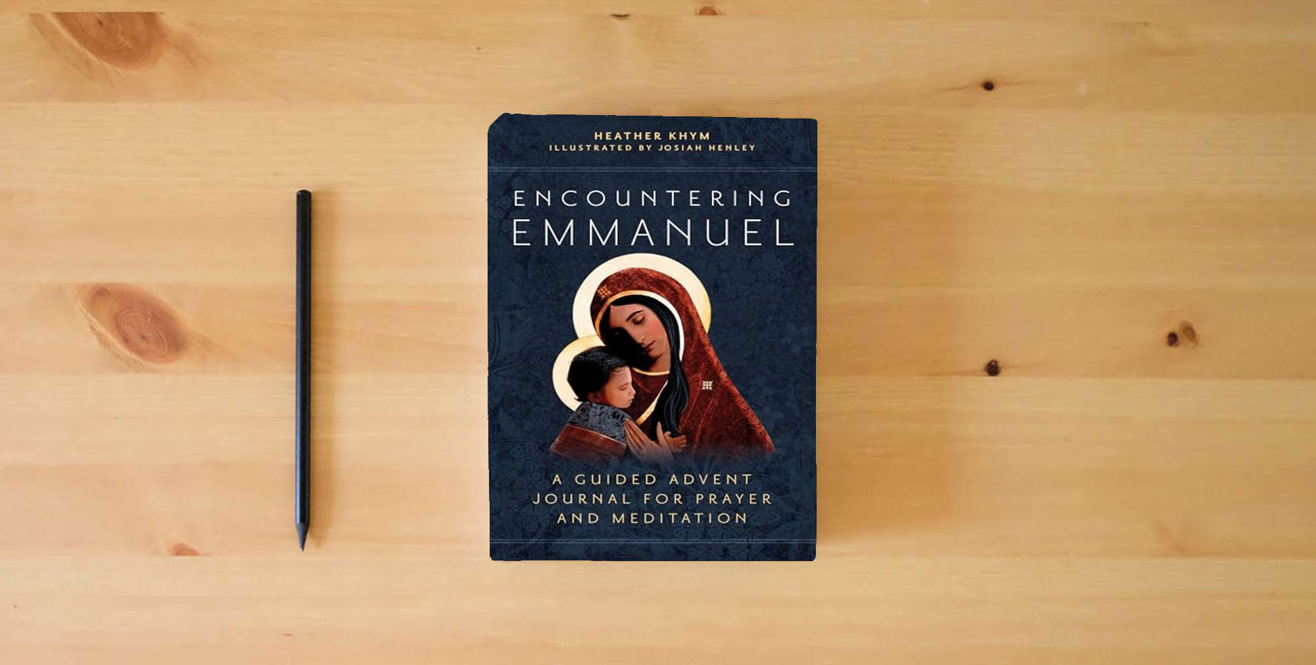 The book Encountering Emmanuel: A Guided Advent Journal for Prayer and Meditation is on the table