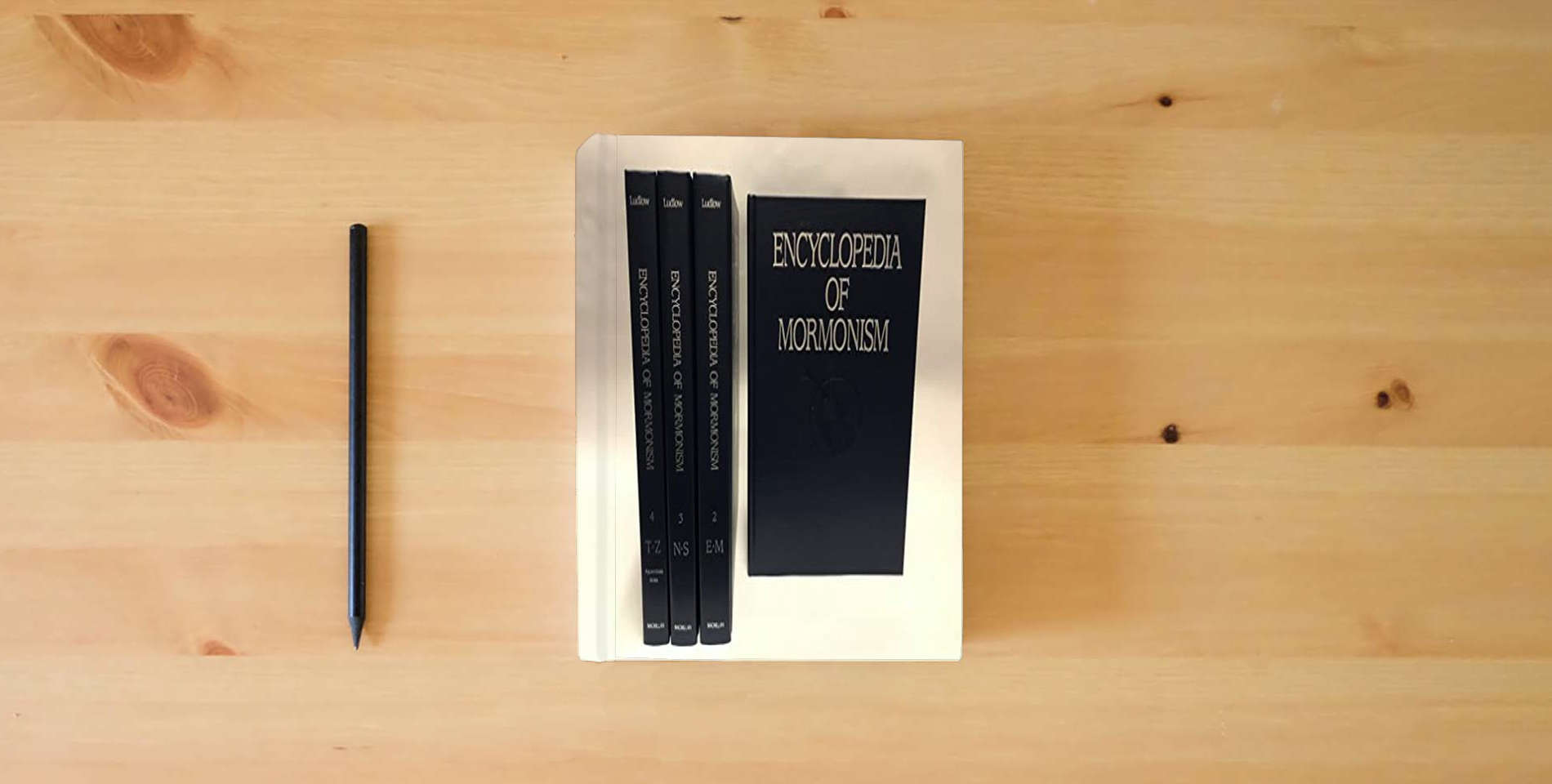 The book Encyclopedia of Mormonism (4-volume set) is on the table
