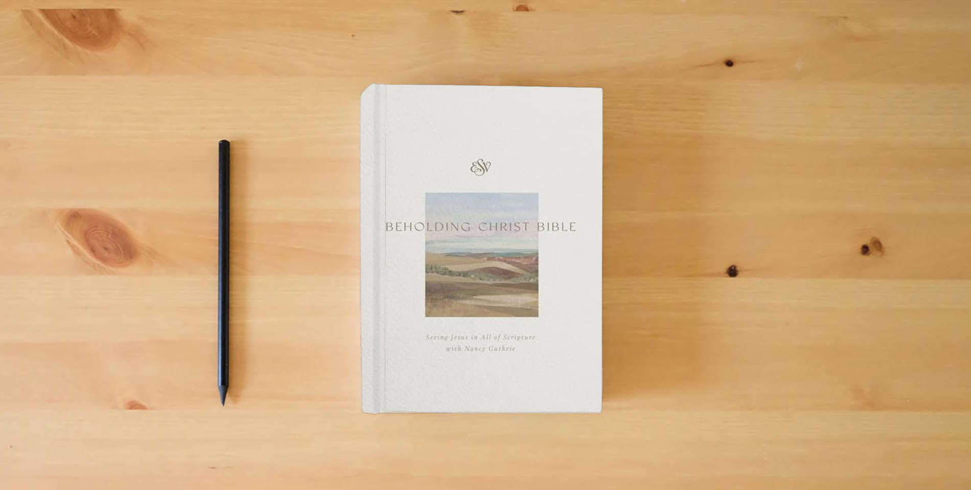 The book ESV Beholding Christ Bible: Seeing Jesus in All of Scripture with Nancy Guthrie (Hardcover) is on the table