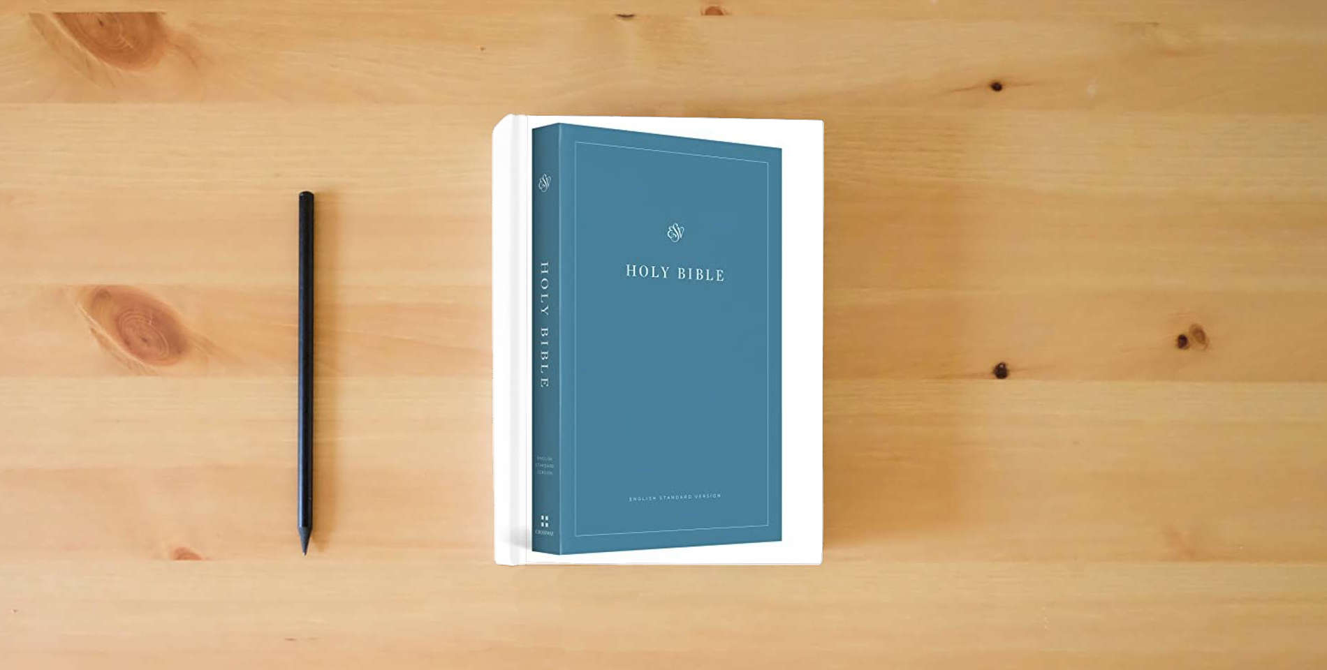 The book ESV Economy Bible is on the table