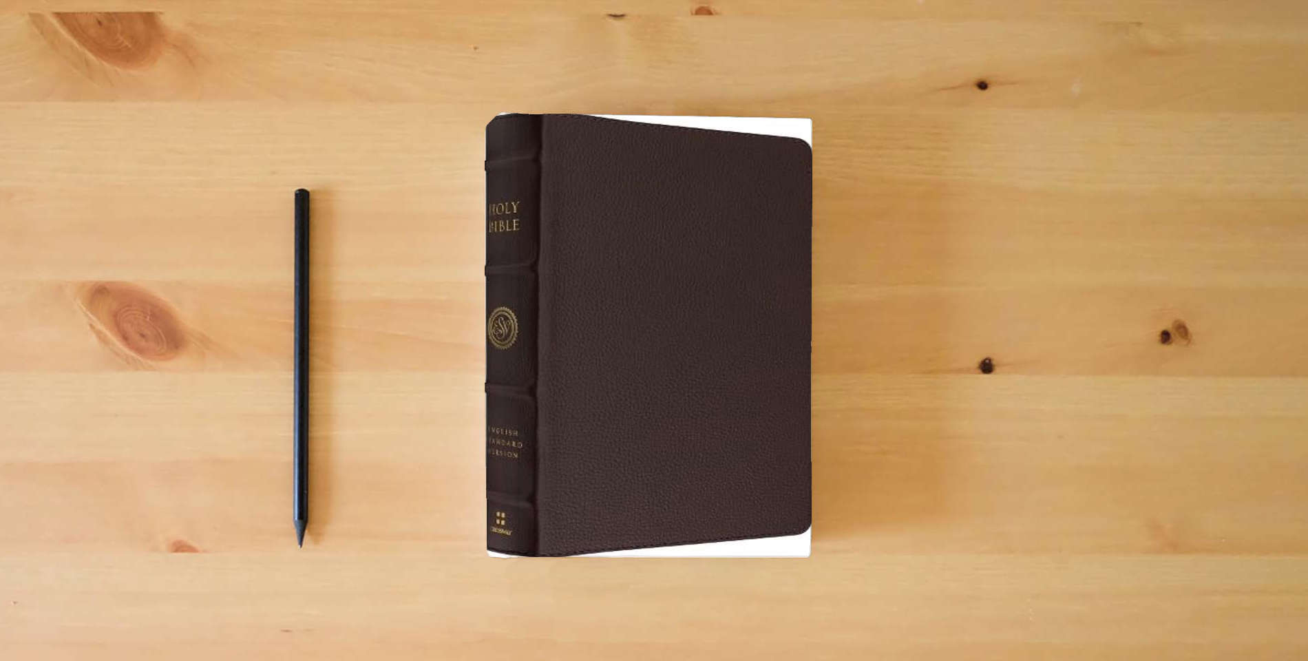 The book ESV Heirloom Bible, Heritage Edition (Calfskin, Mahogany) is on the table