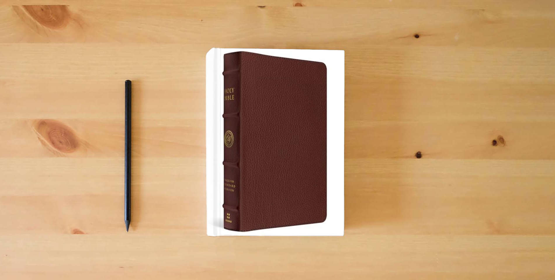 The book ESV Heirloom Bible, Veritas: Single Column Edition (Calfskin, Grenada) is on the table