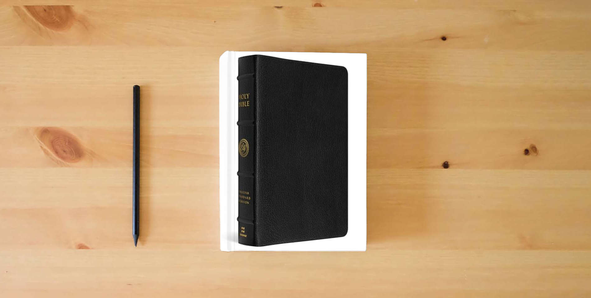 The book ESV Heirloom Bible, Veritas: Single Column Edition (Goatskin, Black) is on the table