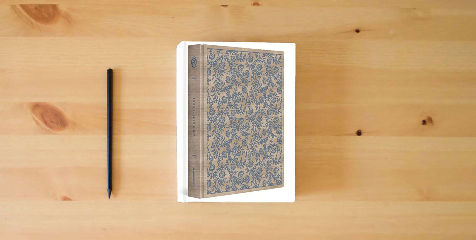 The book ESV Journaling Bible (Cloth over Board, Flowers) is on the table
