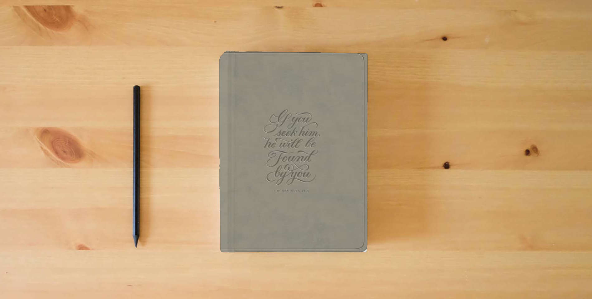 The book ESV Large Print Value Thinline Bible (TruTone, Stone, 1 Chronicles 28:9 Design) is on the table