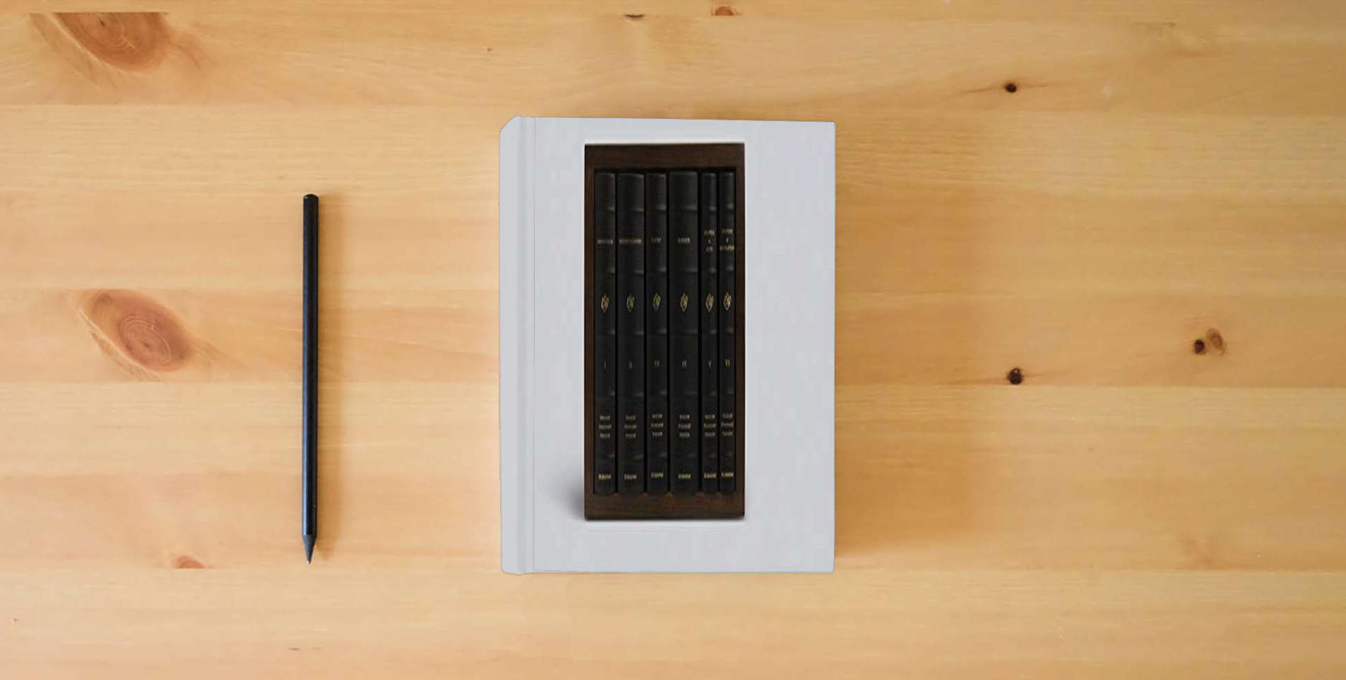 The book ESV Reader's Bible, Six-Volume Set (Cowhide over Board with Walnut Slipcase) is on the table