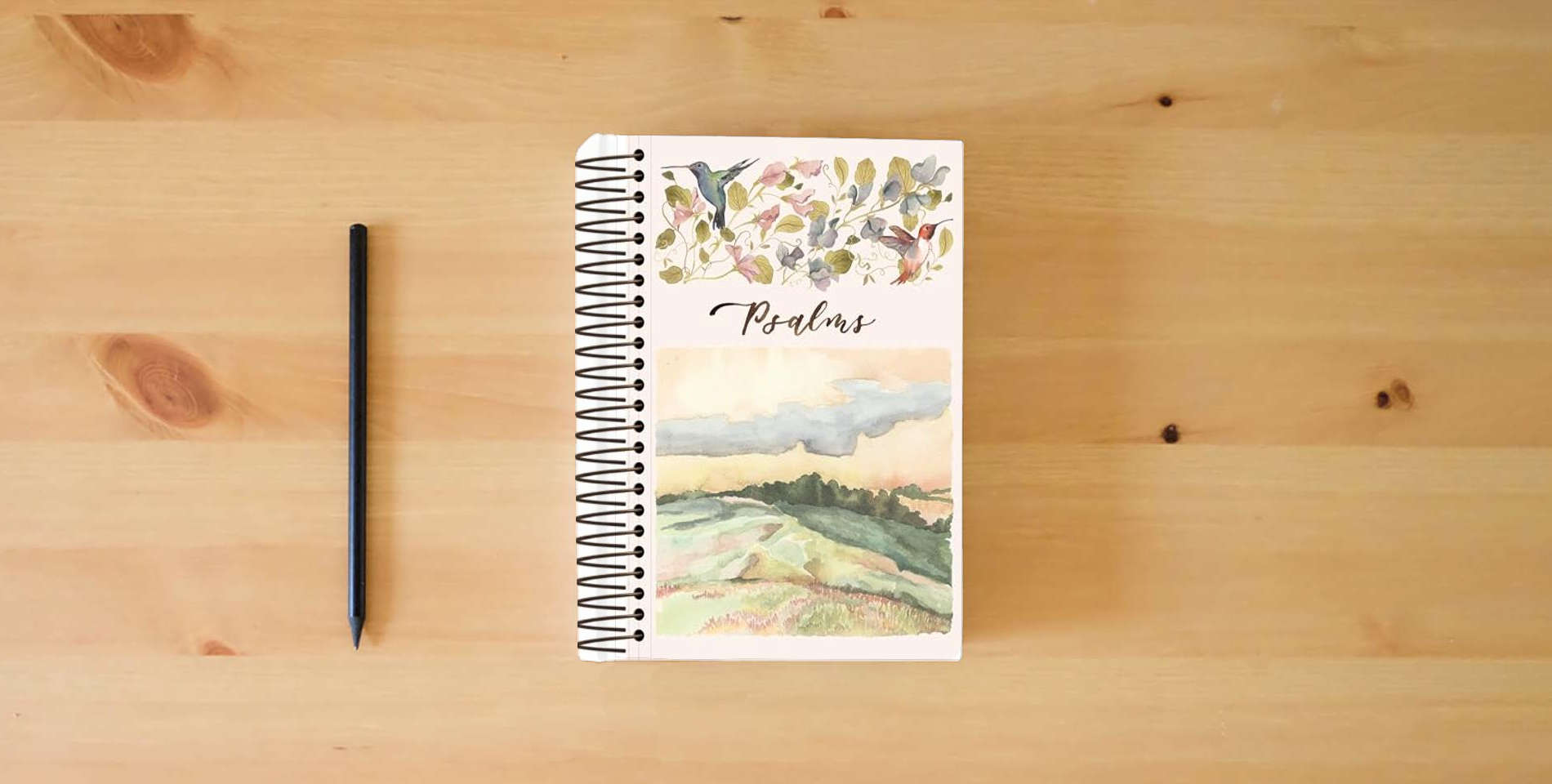 The book ESV Scripture Journal, Spiral-Bound Edition: Psalms (Artwork by Ruth Chou Simons) (Paperback) is on the table