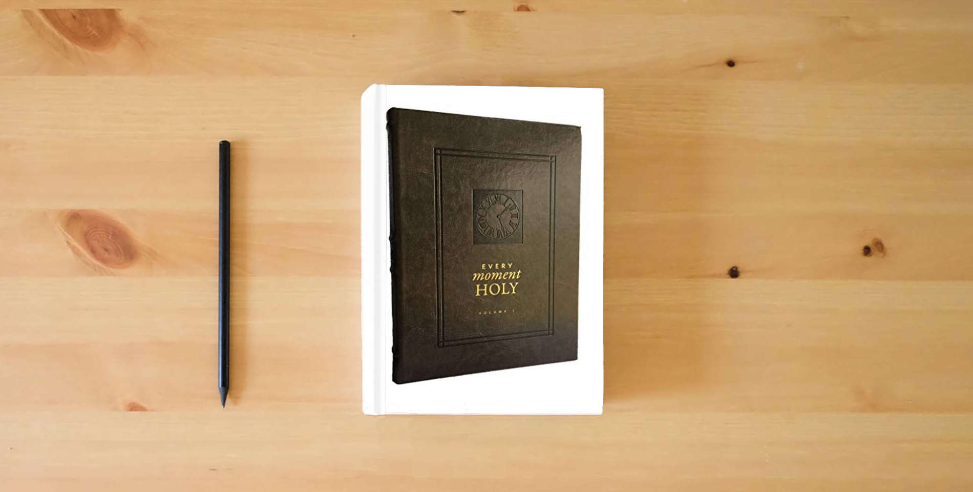 The book Every Moment Holy, Volume I: New Liturgies for Daily Life (Over 100 Prayers and Illustrations for Practicing Mindfulness of the Presence of God in the Ordinary) is on the table