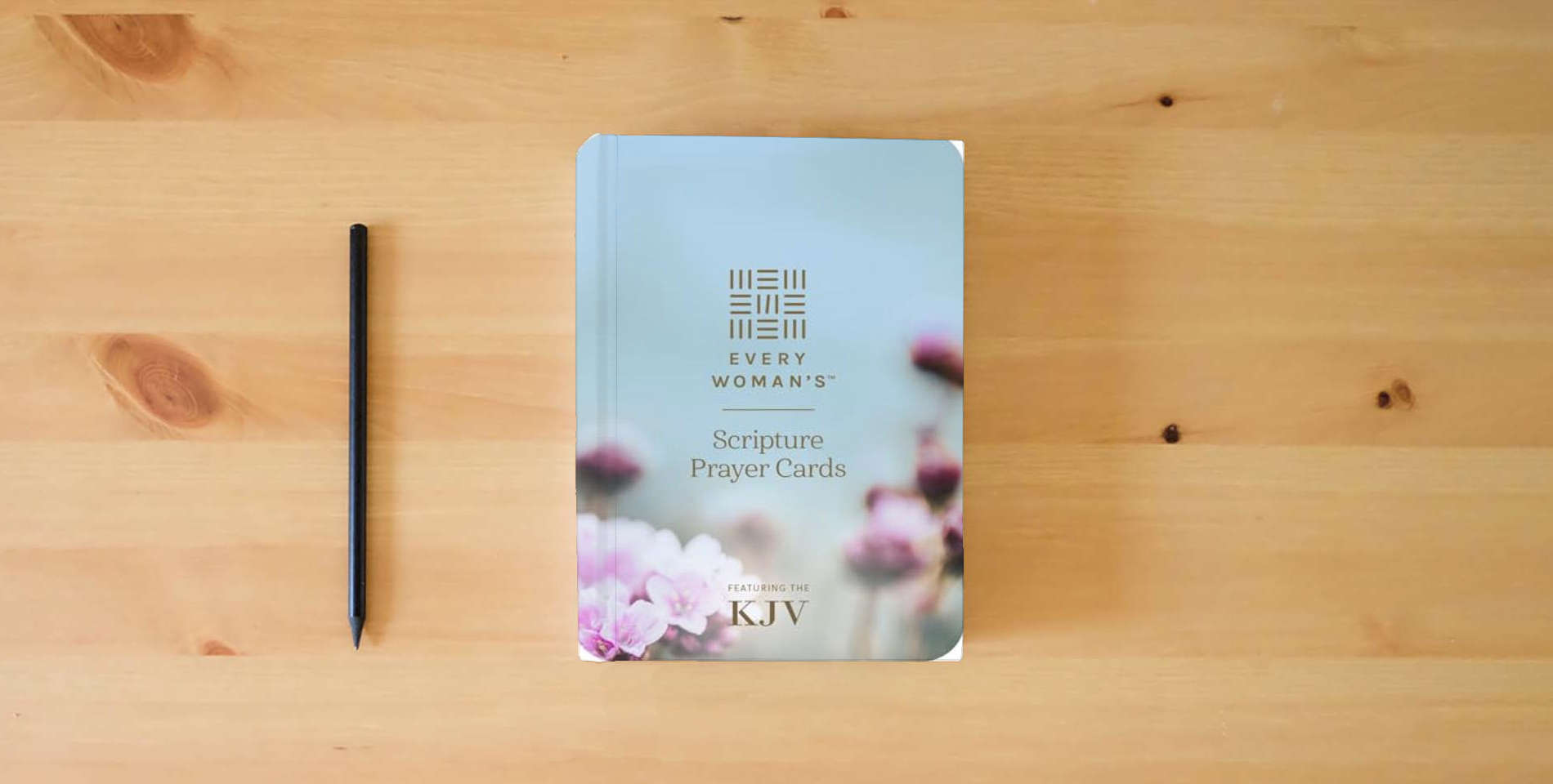The book Every Woman’s Scripture Prayer Cards (Softcover): Featuring the King James Version is on the table