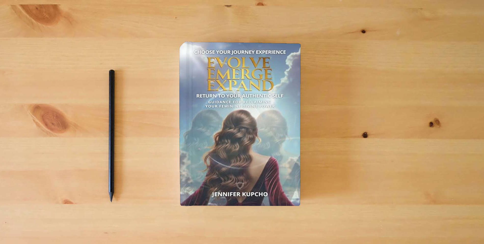 The book Evolve, Emerge, Expand: Return to Your Authentic Self is on the table