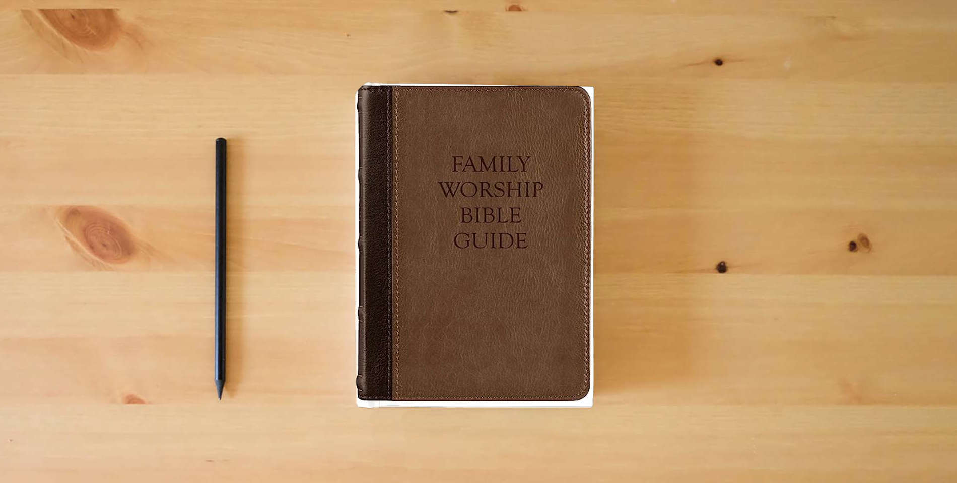 The book Family Worship Bible Guide (Two-Tone Brown) is on the table