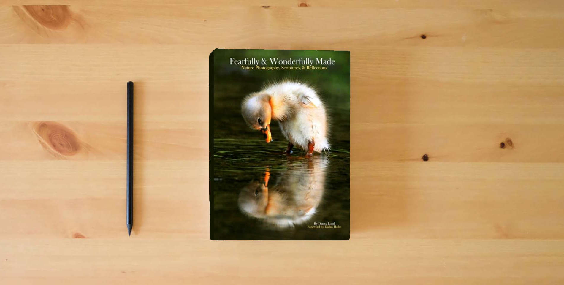 The book Fearfully & Wonderfully Made: Nature Photography, Scriptures, & Reflections is on the table