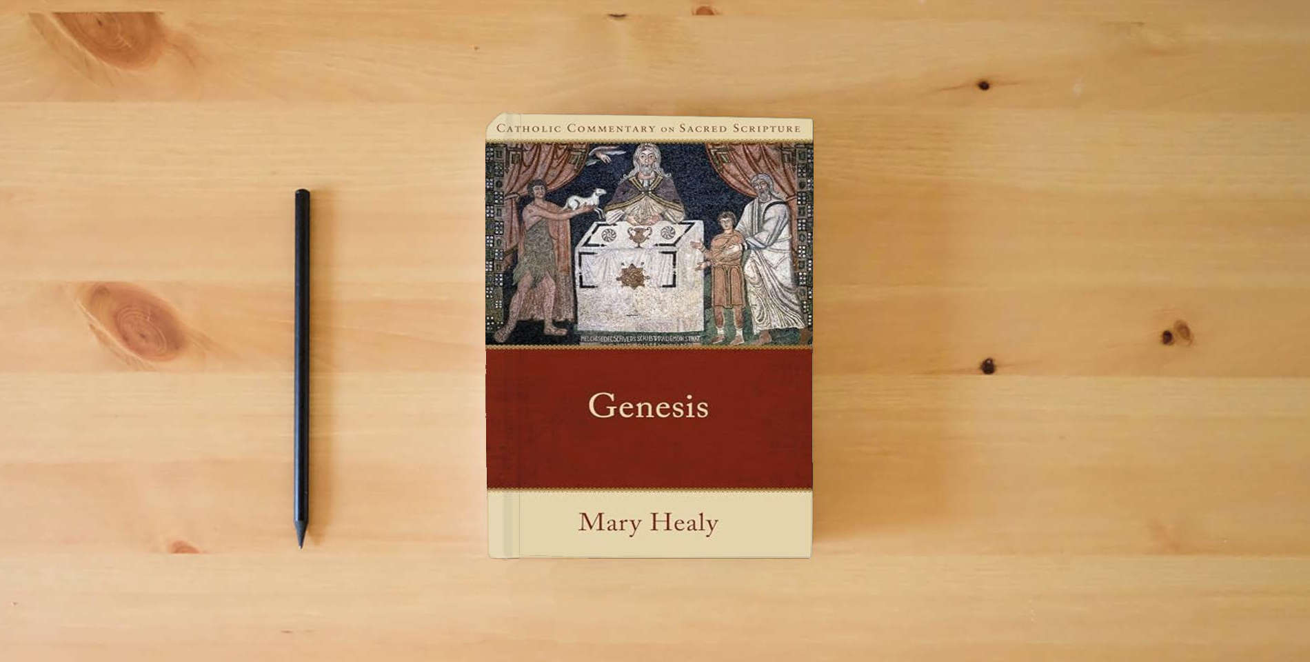 The book Genesis: (A Catholic Bible Commentary on the Old Testament by Trusted Catholic Biblical Scholars - CCSS) (Catholic Commentary on Sacred Scripture) is on the table
