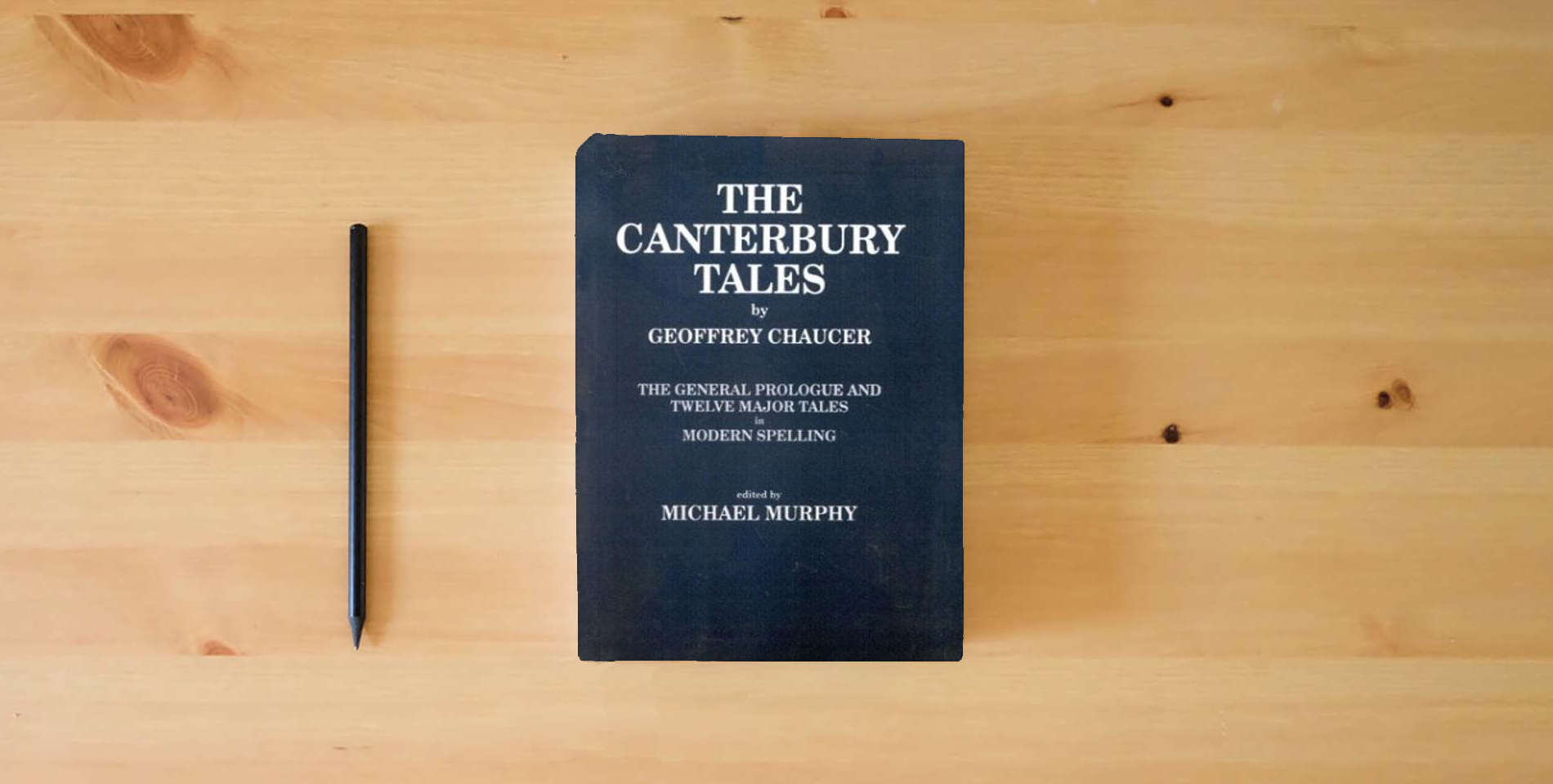 The book Geoffrey Chaucer is on the table