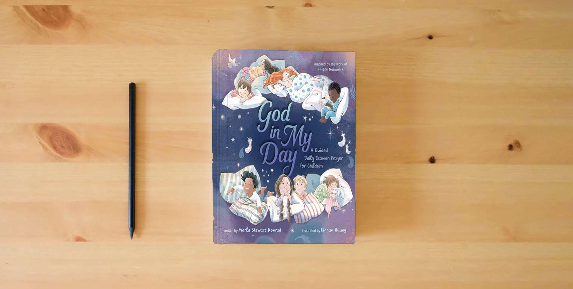 The book God in My Day: A Guided Daily Examen Prayer for Children is on the table