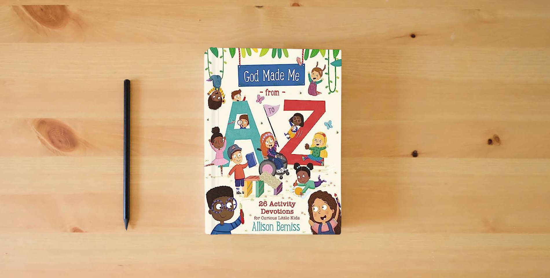 The book God Made Me from A to Z: 26 Activity Devotions for Curious Little Kids is on the table