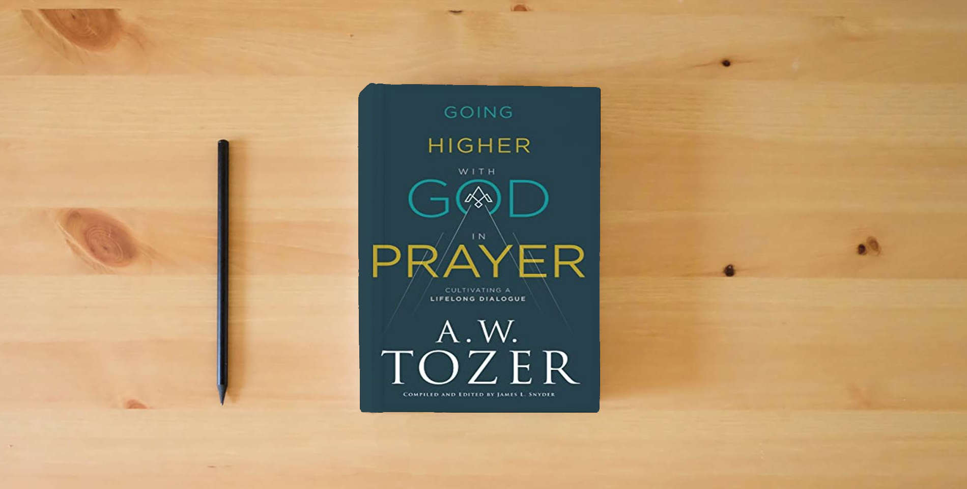 The book Going Higher with God in Prayer: Cultivating a Lifelong Dialogue is on the table