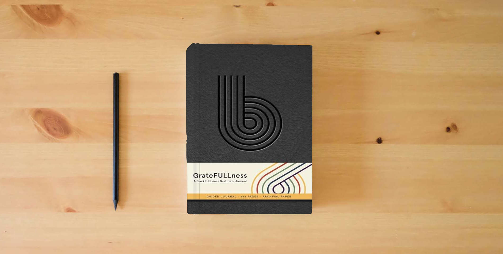 The book GrateFULLness: A BlackFULLness Gratitude Journal is on the table