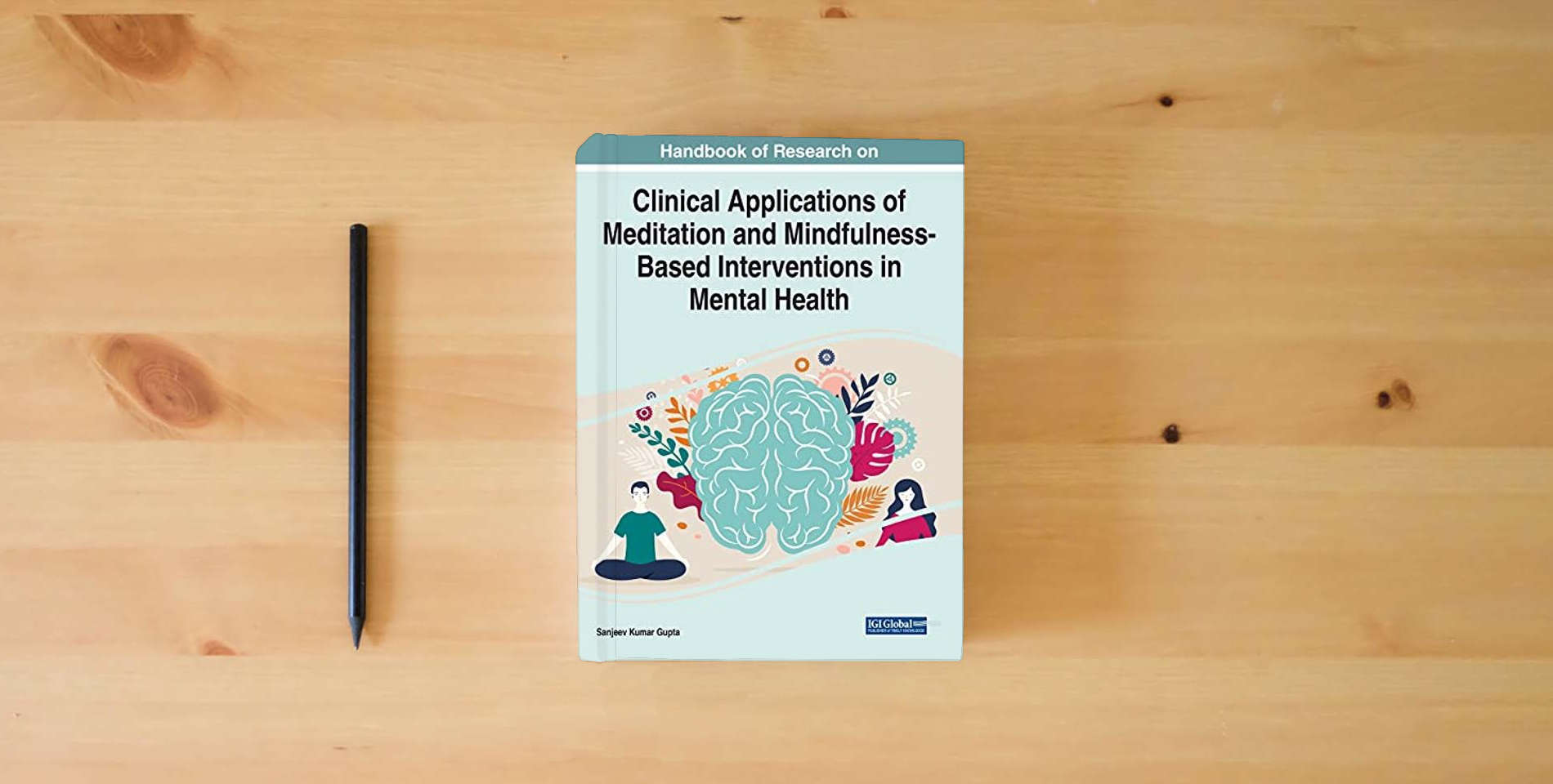 The book Handbook of Research on Clinical Applications of Meditation and Mindfulness-Based Interventions in Mental Health (Advances in Psychology and Behavioral Studies) is on the table
