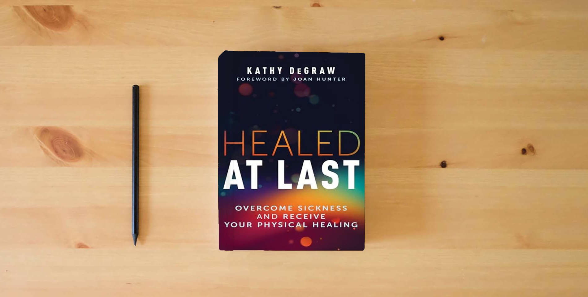 The book Healed at Last: Overcome Sickness and Receive Your Physical Healing is on the table
