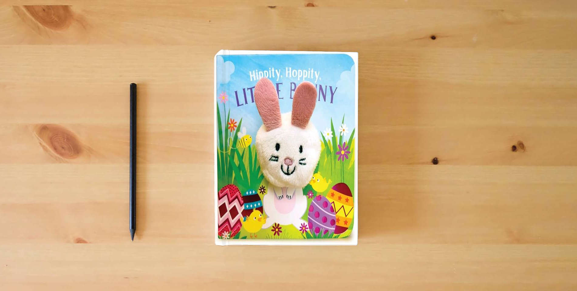 The book Hippity, Hoppity, Little Bunny - Finger Puppet Board Book for Easter Basket Gifts or Stuffer Ages 0-3 is on the table
