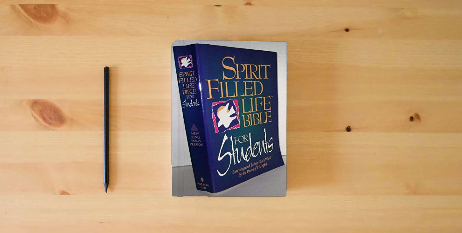 The book Holy Bible: Spirit Filled Life Bible for Students, New King James Version is on the table