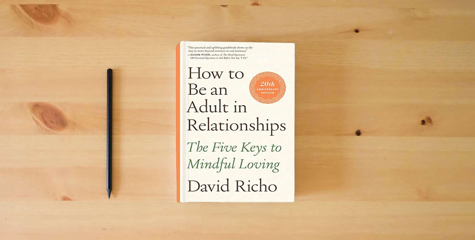 The book How to Be an Adult in Relationships: The Five Keys to Mindful Loving is on the table