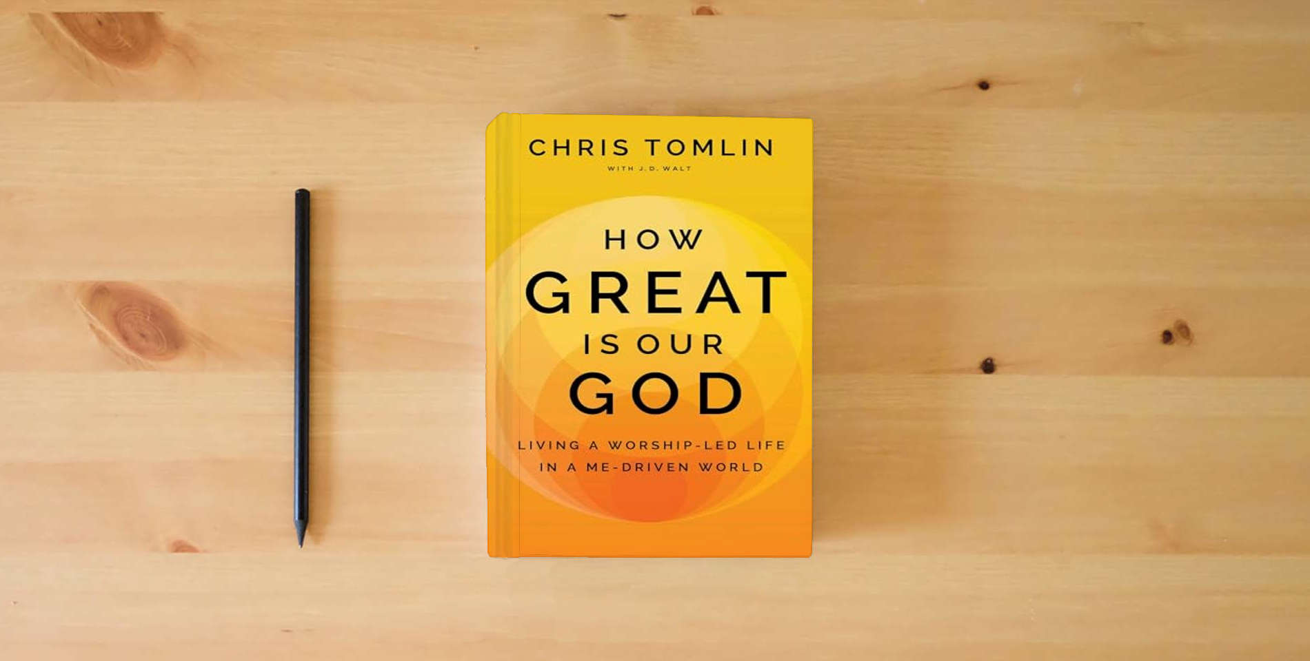 The book How Great Is Our God: Living a Worship-Led Life in a Me-Driven World is on the table