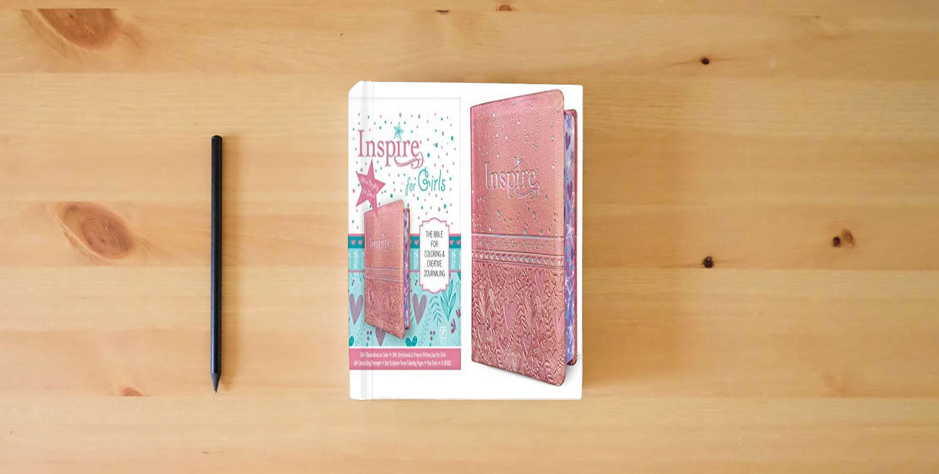 The book Inspire Bible for Girls NLT (LeatherLike, Pink): The Bible for Coloring & Creative Journaling is on the table