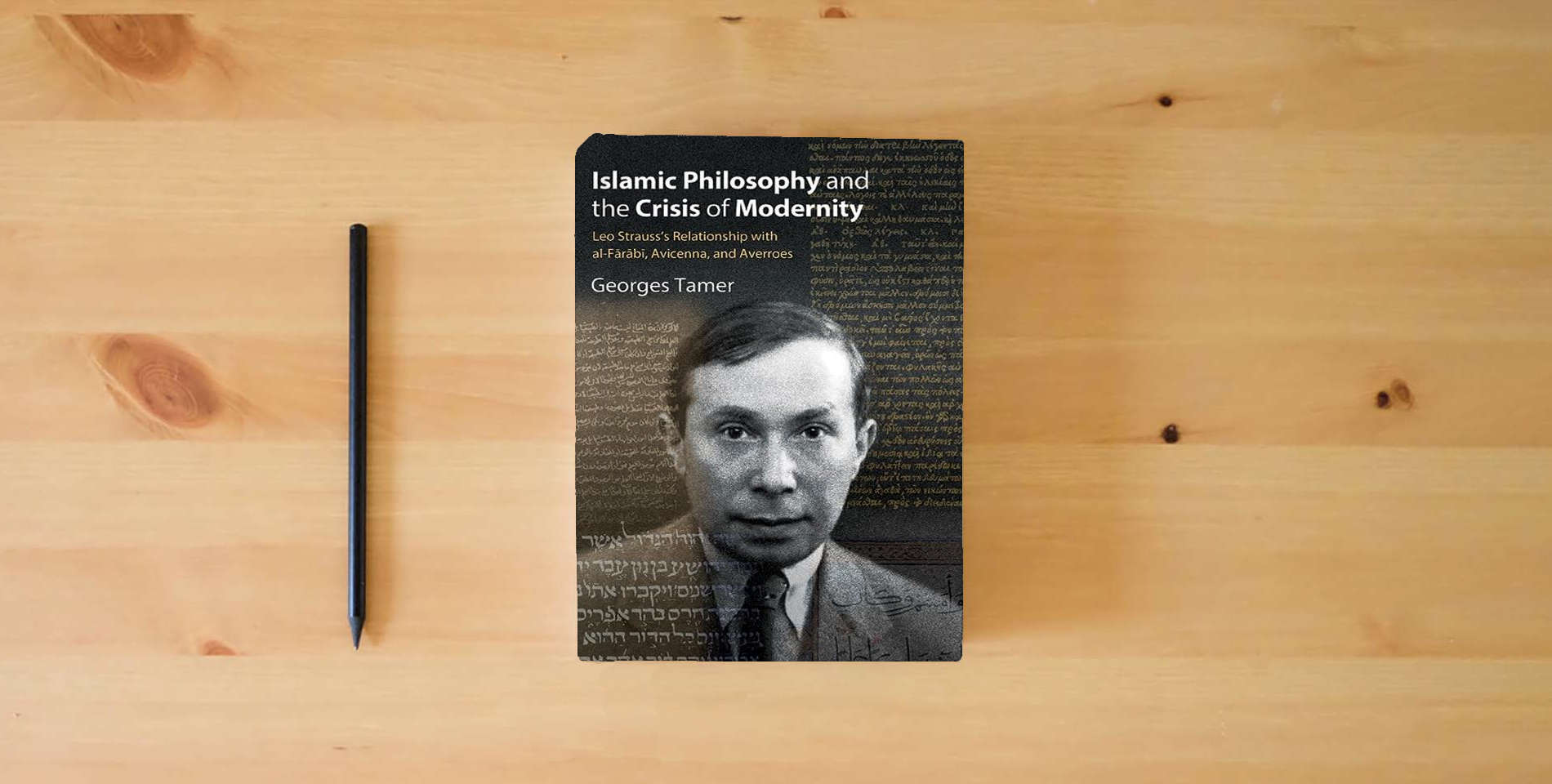 The book Islamic Philosophy and the Crisis of Modernity: Leo Strauss's Relationship with Al-Fārābī, Avicenna, and Averroes (Suny the Thought and Legacy of Leo Strauss) is on the table