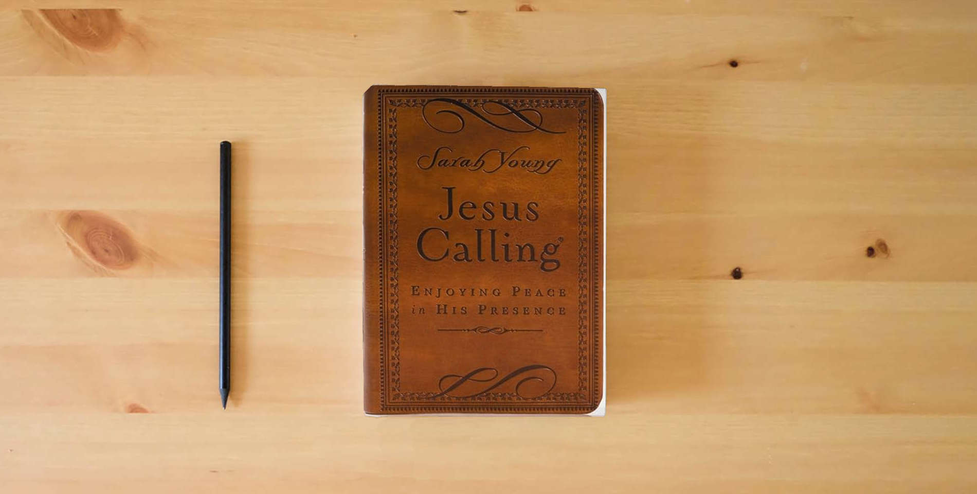 The book Jesus Calling, Small Brown Leathersoft, with Scripture References: Enjoying Peace in His Presence (A 365-Day Devotional) is on the table