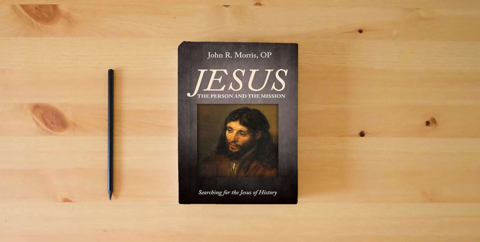 The book Jesus: The Person and the Mission: Searching for the Jesus of History is on the table