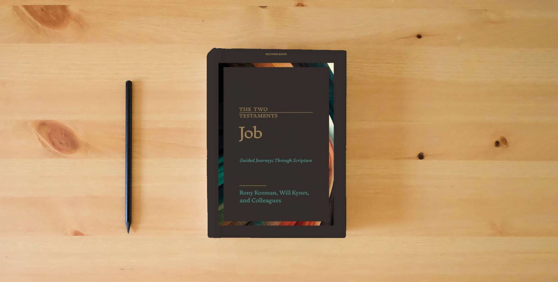 The book Job (The Two Testaments: Guided Journeys Through Scripture) is on the table