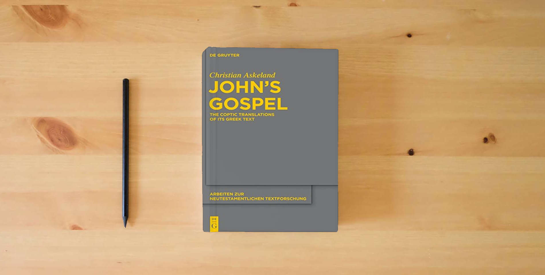 The book John's Gospel: The Coptic Translations of its Greek Text (Arbeiten zur neutestamentlichen Textforschung, 44) is on the table