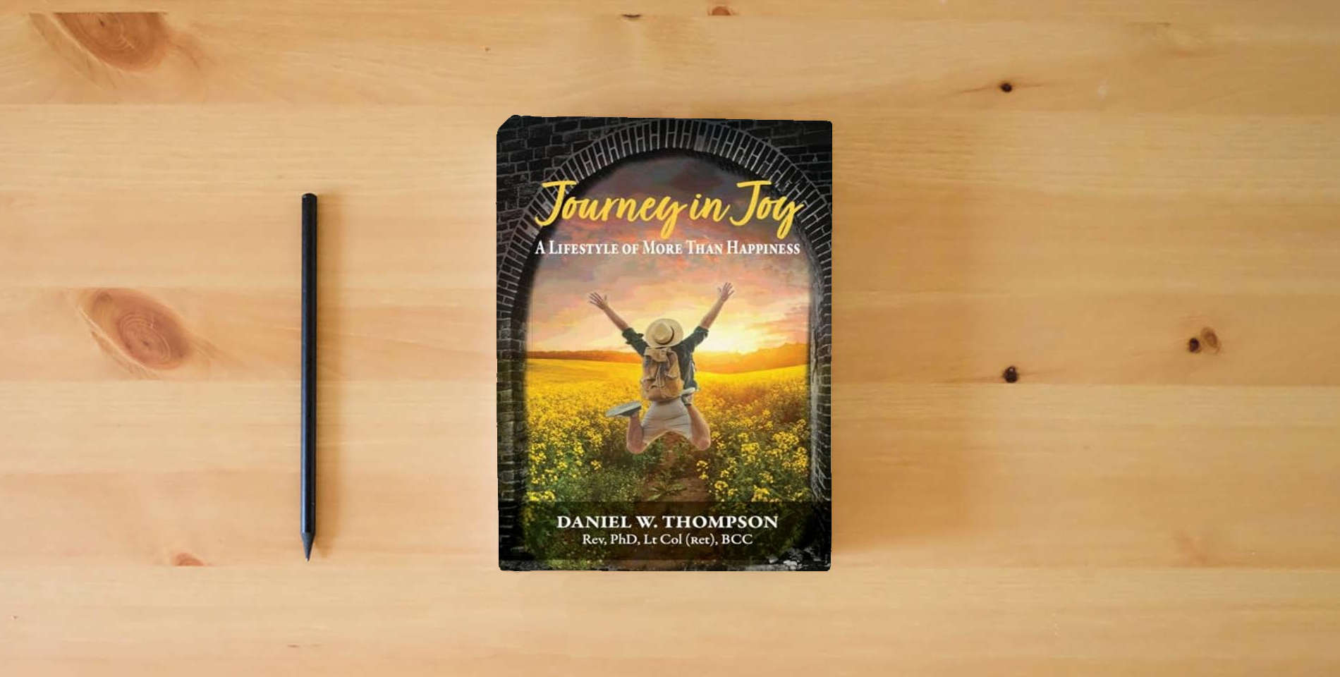 The book Journey in Joy: A Lifestyle of More Than Happiness is on the table