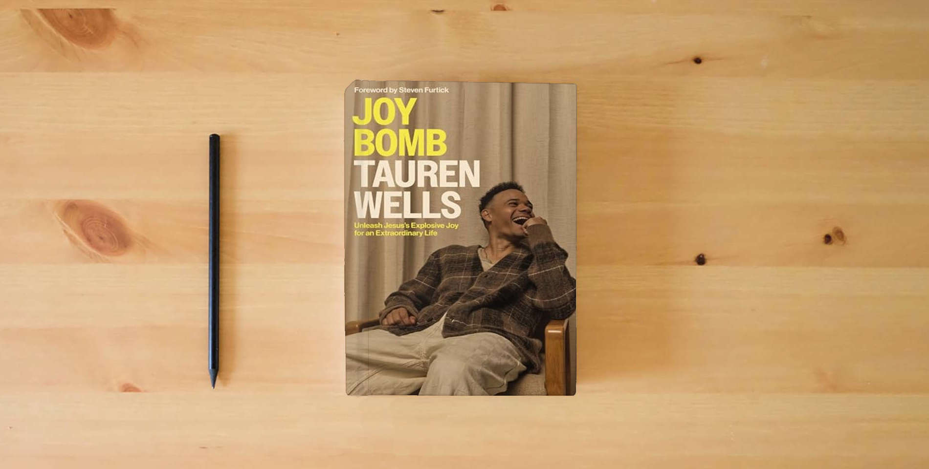 The book Joy Bomb: Unleash Jesus's Explosive Joy for an Extraordinary Life is on the table