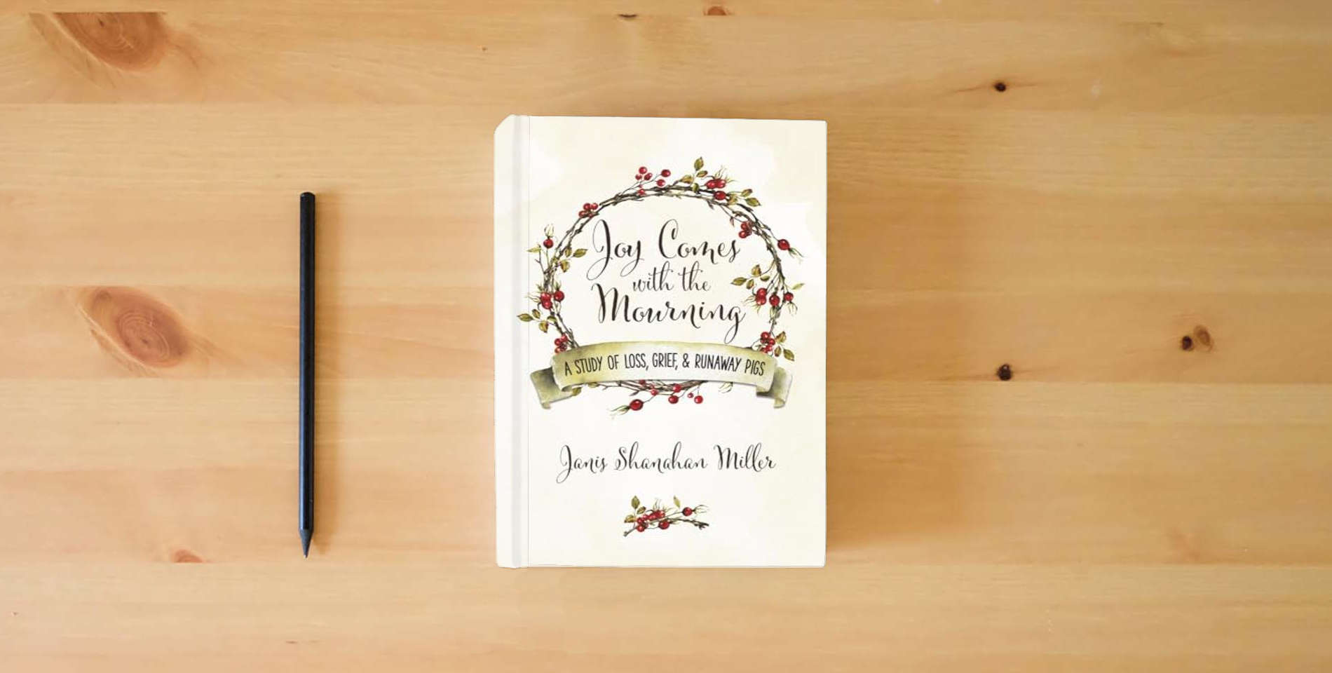 The book Joy Comes with the Mourning: A Study of Loss, Grief, and Runaway Pigs is on the table
