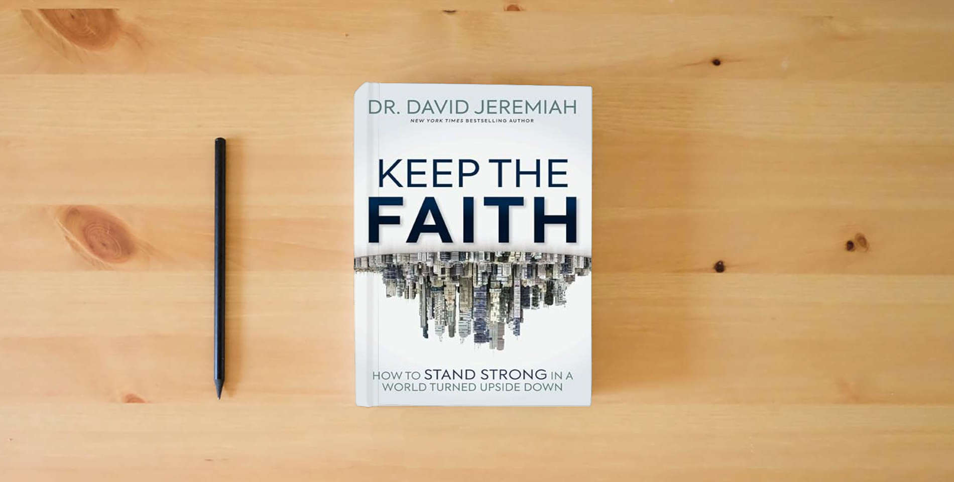 The book Keep the Faith: How to Stand Strong in a World Turned Upside-Down is on the table