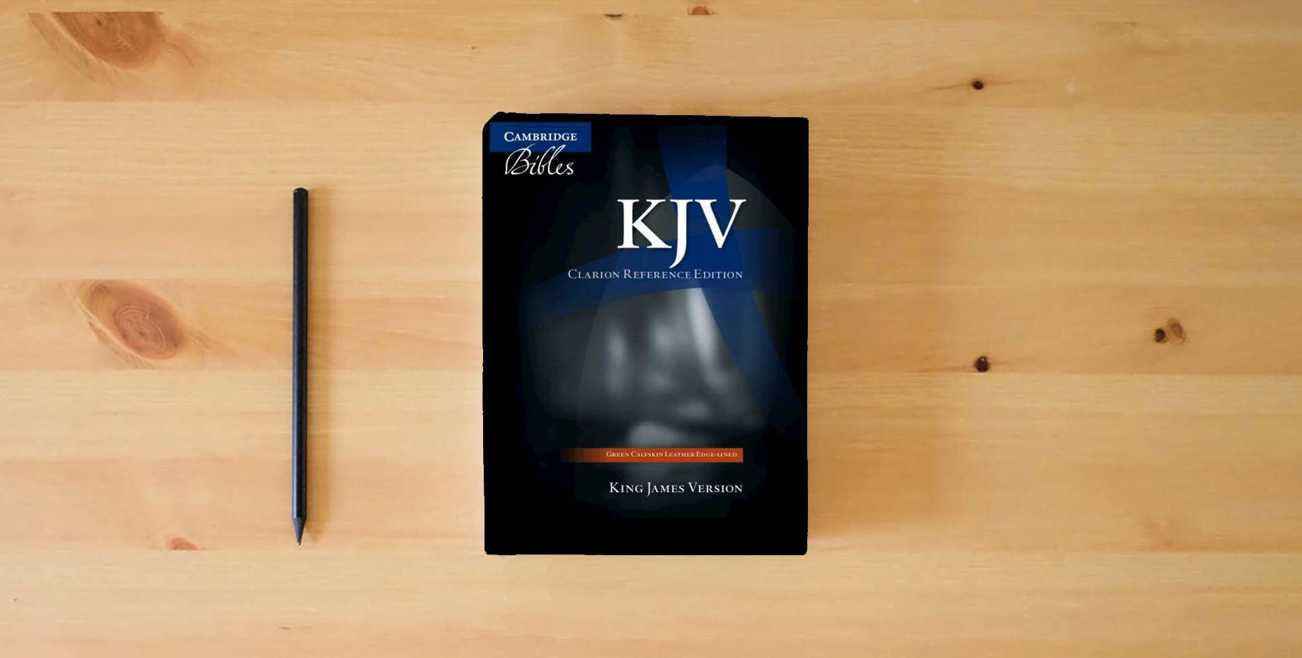 The book KJV Clarion Reference Bible, Dark Green Buffalo Calfskin Leather, Full Yapp, KJ485:XLY is on the table
