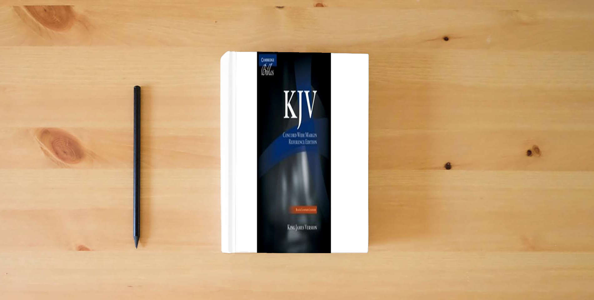 The book KJV Concord Wide Margin Reference Bible, Black Edge-lined Goatskin Leather, KJ766:XME is on the table