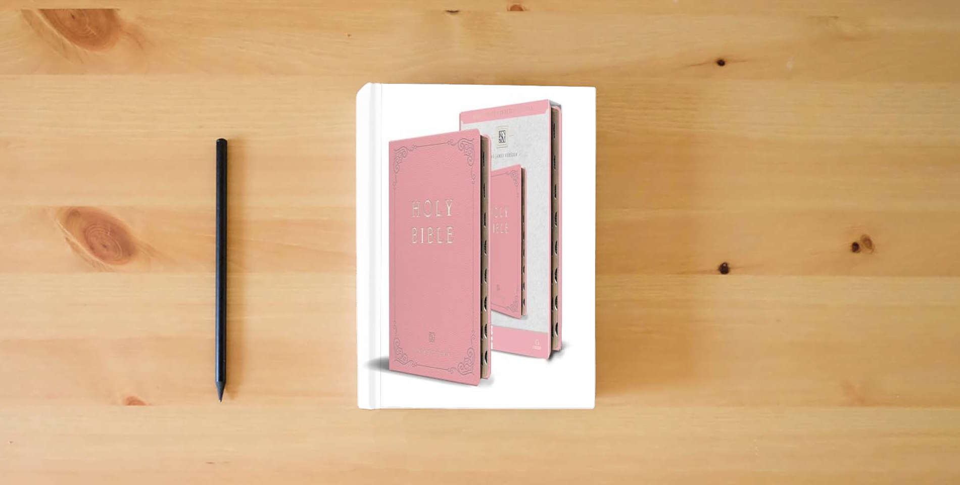The book KJV Holy Bible, Giant Print Thinline Large format, Pink Premium Imitation Leathe r with Ribbon Marker, Red Letter, and Thumb Index is on the table
